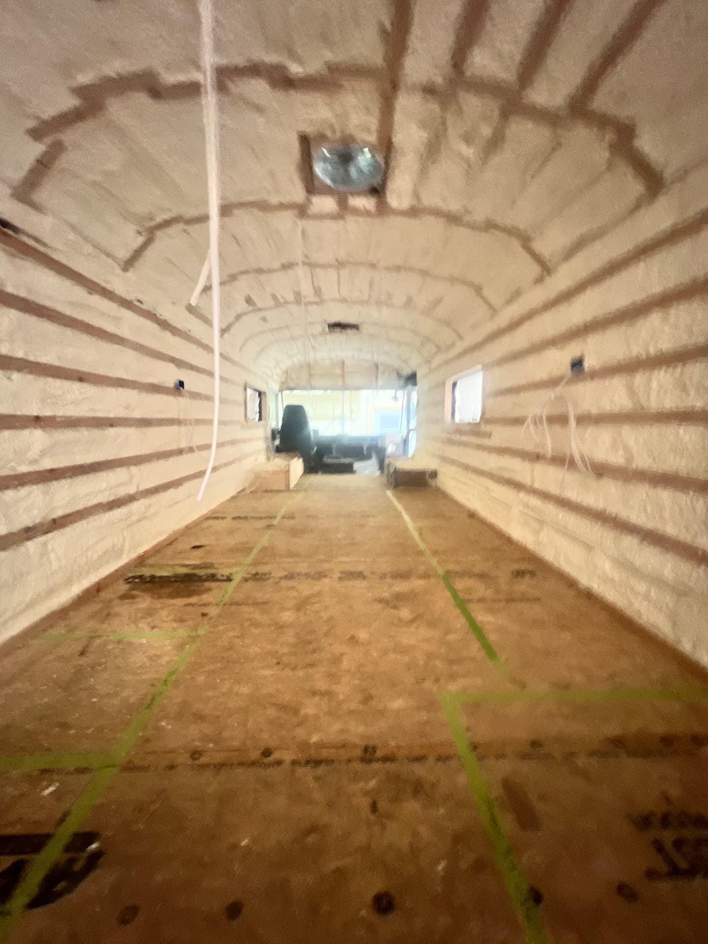 Skoolie shell insulated and framed during a custom conversion build